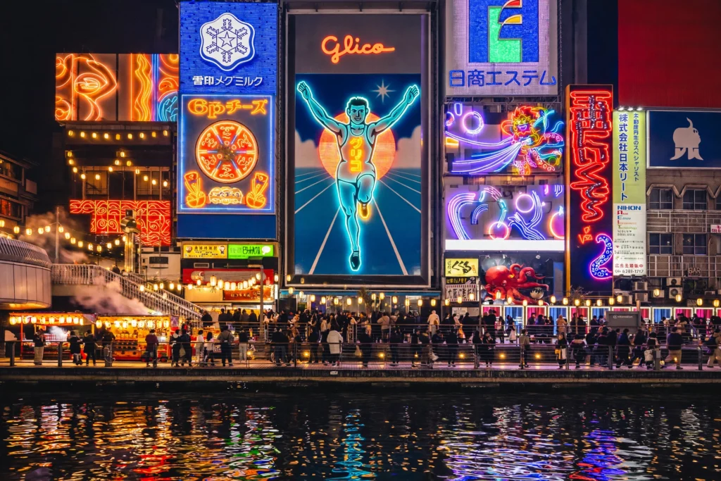 9-Day Japan Itinerary: Tokyo, Kyoto, and Osaka for First-Time Visitors 3 Dotonbori canal in Osaka at night with neon signs and the Glico running man billboard reflected in the water.