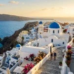 Whitewashed village on a cliffside overlooking the sea, among the best islands to visit in Greece