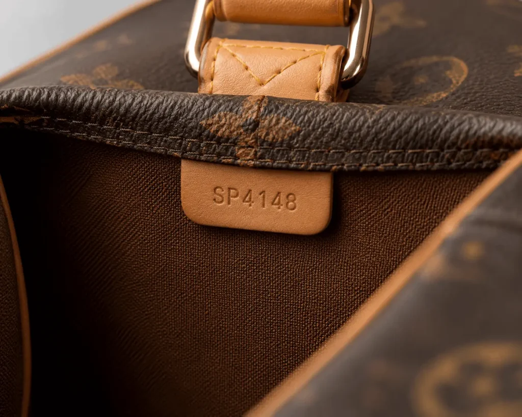 Louis Vuitton Travel Bag: Full Buying Guide 2026 3 Close-up of Louis Vuitton travel bag interior date code and stitching used to check authenticity