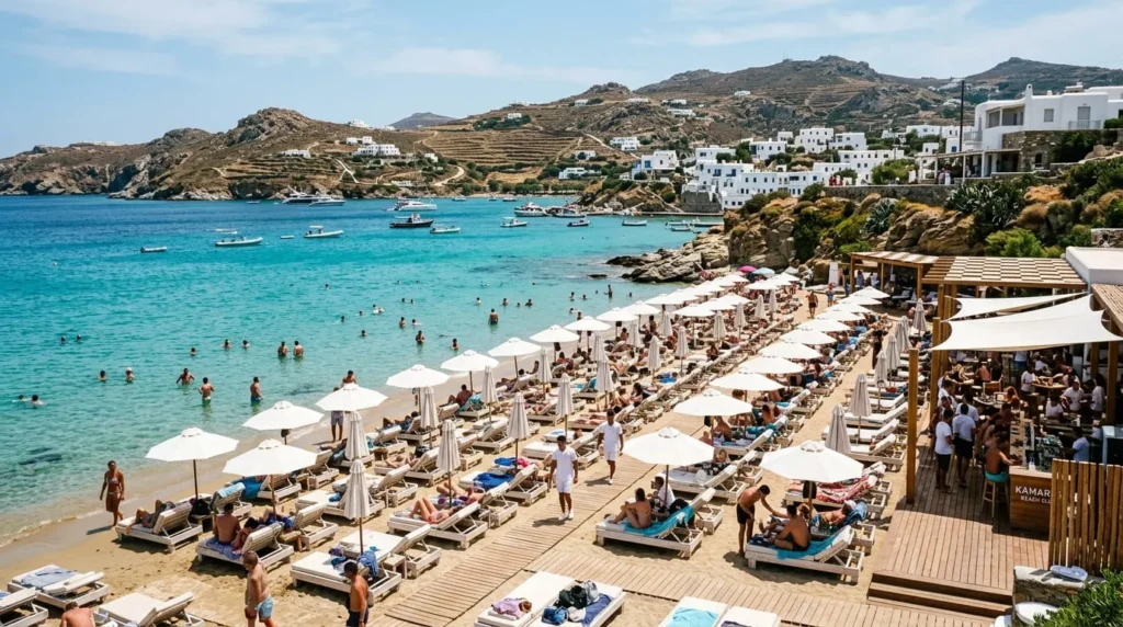 Best Islands to Visit in Greece: The Complete Guide 3 Text: Beach club with sun loungers by turquoise water on one of the best islands to visit in Greece