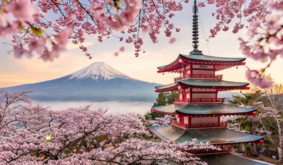 Mount Fuji with Chureito Pagoda and cherry blossoms at sunrise, one of the best places to visit in Japan.