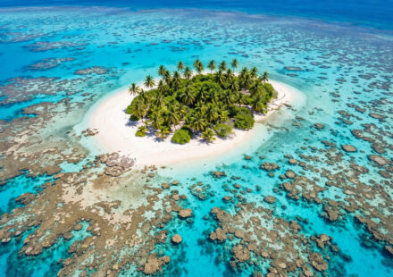 Aerial view of a turquoise lagoon and white-sand beach in the Mamanuca Islands, Fiji.