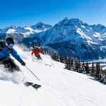 Skiers descending a snowy alpine slope, one of the best places to go skiing worldwide