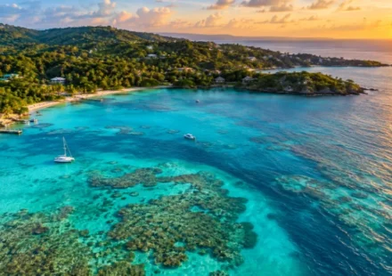 Turquoise water and coral reef along the coast of Roatan, one of the best things to do in Honduras
