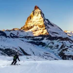 Skiers below the Matterhorn at one of the best places to go skiing in the Alps.