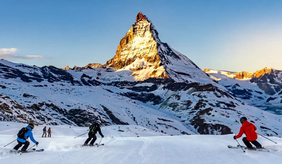 Skiers below the Matterhorn at one of the best places to go skiing in the Alps.