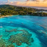 Turquoise water and coral reef along the coast of Roatan, one of the best things to do in Honduras