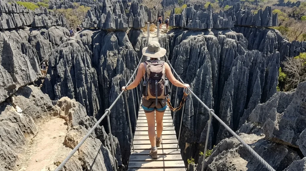 Hiker crossing a bridge in Tsingy de Bemaraha, a top thing to do in Madagascar
