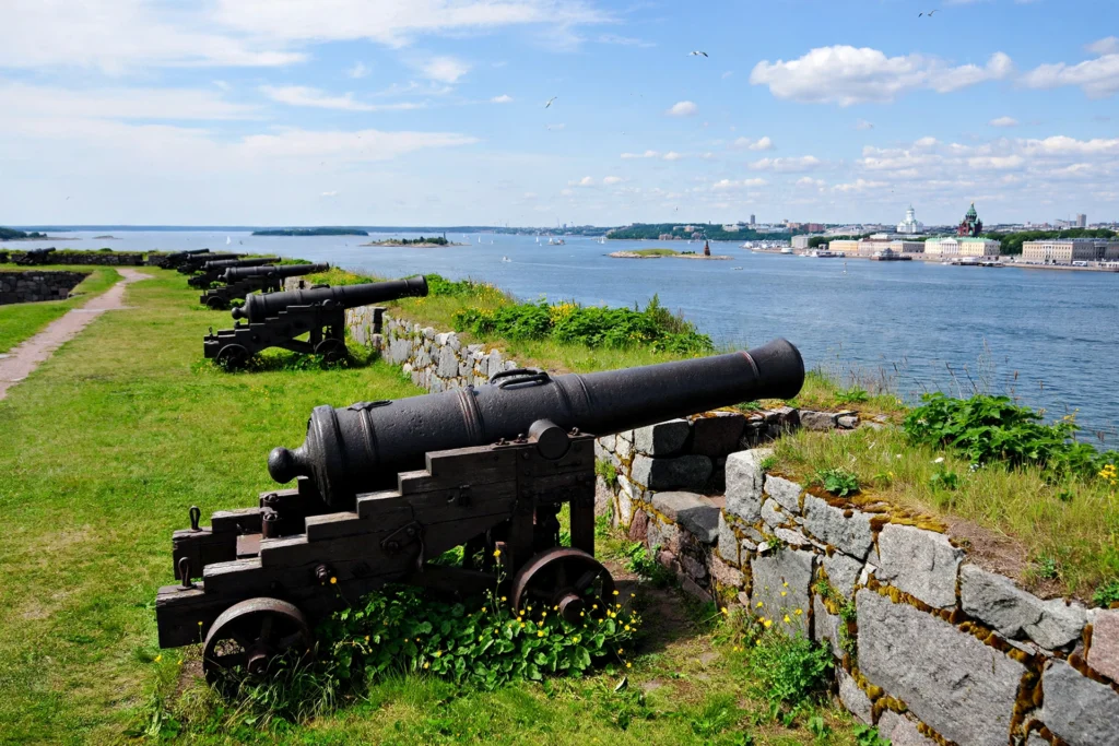 Historic cannons on the stone ramparts of Suomenlinna Sea Fortress in Helsinki.